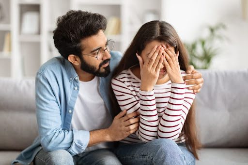 Husband comforting wife following a miscarriage