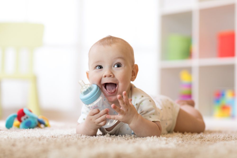 Cute baby drinking from bottle